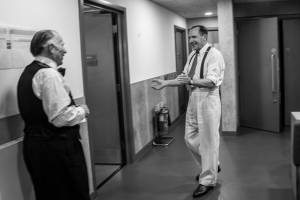 Ralph Fiennes and Danny Webb laugh backstage.