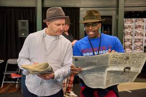 Mark Oxtoby and Cedric Neal look over a newspaper together