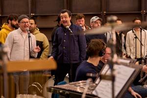Mark Oxtoby and Danny Mays stand singing into a microphones.