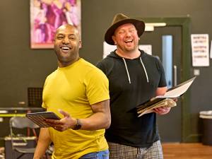 Jonathan Andrew Hume and Ryan Pidgen laugh in rehearsals with scripts in hand.