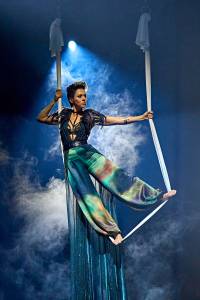 Titania stands in aerial silks