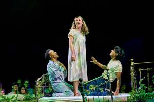 Helena stands with Demetrius and Lysander at her feet