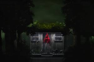 Little Red Ridinghood stands outside Grandmother's House